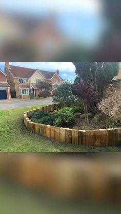 a wooden garden bed in the middle of a yard