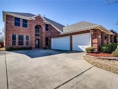 a large brick house with two garages