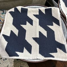 two blue and white rugs sitting on top of a wooden table