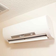 a white air conditioner mounted on the ceiling