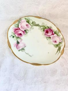 Enhance your dining experience with this exquisite vintage porcelain plate adorned with delicate pink roses. The elegant gold trim adds a touch of sophistication to any table setting. Perfect for serving appetizers or as a decorative piece. - Measures approximately 7 inches in diameter This charming plate seamlessly combines functionality with aesthetic appeal, making it a wonderful addition to your home decor. Porcelain Plate, Lancaster Pa, Porcelain Plates, Vintage Porcelain, Dining Experience, Serving Plates, Lancaster, Gold Trim, Table Setting