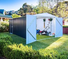 a garden shed with its doors open in the yard