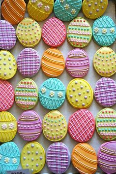 colorful decorated cookies are displayed in a box