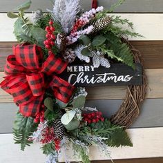 a christmas wreath hanging on the side of a wooden wall