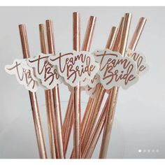 pink and gold straws with the words team bride on them