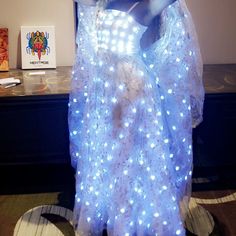 a mannequin dressed in white with blue lights