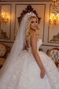 a woman in a wedding dress posing for the camera