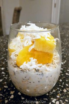 a glass bowl filled with food on top of a table