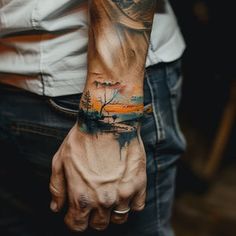 a man with a tattoo on his arm that has an image of a boat in the water