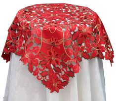 a red and white table cloth with poinsettis on it