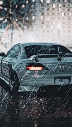 a car parked in the rain on a city street