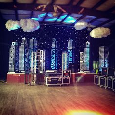 an empty stage with lights and clouds in the air above it, set up for a show