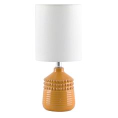 an orange table lamp with a white shade on the base and a light bulb attached to it