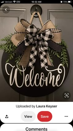 a black and white welcome sign hanging on a door