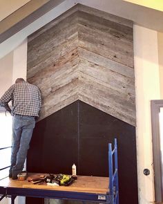 a man standing on top of a wooden shelf