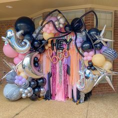 balloons and streamers decorate the entrance to a party