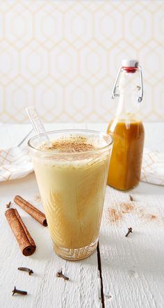 an iced drink with cinnamon sticks next to it