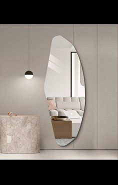 a mirror that is on the side of a wall next to a table and chair