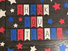 the words thank you veterans written in red, white and blue stars on a wood background