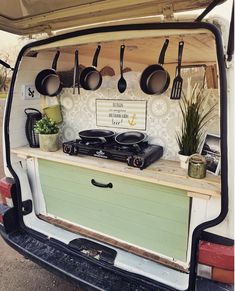 the back end of a van with pots and pans on it