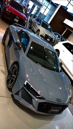 several cars are on display in a showroom