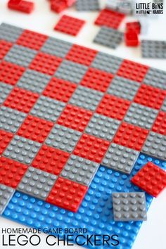 the lego checker board is made with red and gray blocks