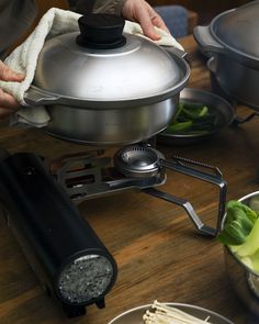 a person is using a large pot on the stove