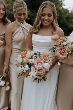 the bridesmaids are holding their bouquets together