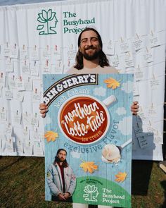 a man is holding up a sign that says bengerry's ice cream