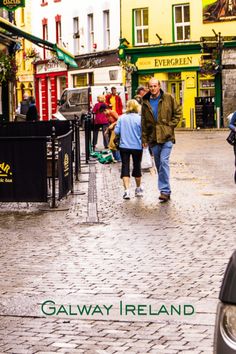 people walking down the street in front of shops