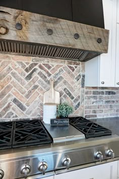 a stove top oven sitting inside of a kitchen next to a wall mounted range hood