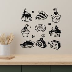 a wall decal with different types of cakes and pastries in black on a white background