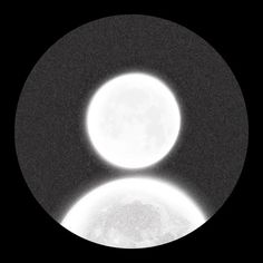 two white circles are shown in the dark sky with light shining on them and behind them is a black background