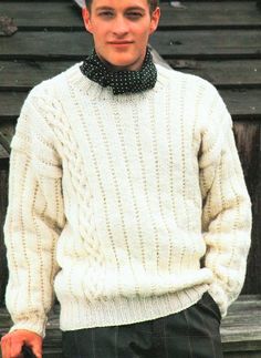 a young man wearing a white sweater and bow tie