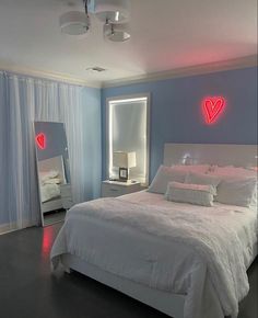 a bed room with a neatly made bed next to a night stand and two lights