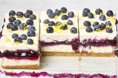 there are four slices of cake with blueberries on top