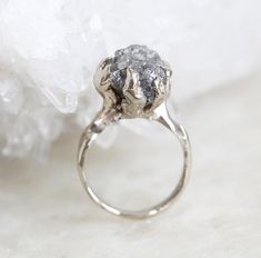 a diamond ring sitting on top of a piece of ice