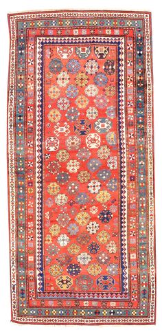 an orange, blue and red rug with multicolored designs on the bottom corner