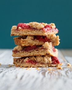 three strawberry crumb bars stacked on top of each other