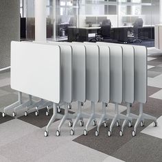 an office cubicle with four partitions on wheels in front of the desk and chairs