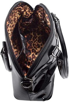 This gothic chic handbag is part of the Macabre Mobile Black Collection by Elvira Mistress of the Dark. It features an embroidered spider web pattern on black vinyl, metal bullet feet, a detachable metal spider charm, and a removable shoulder strap. There is one large pocket behind the web on the front of the bag. The interior of the bag has a leopard print liner, two small pockets, one large pocket, and a key holding clip. Secures with a full zipper closure. Measures approximately 9"x12"x5", sh Metal Spider, Spider Web Pattern, Kreepsville 666, Elvira Mistress Of The Dark, Gothic Chic, Web Patterns, Chic Handbags, Black Vinyl, Sling Backpack