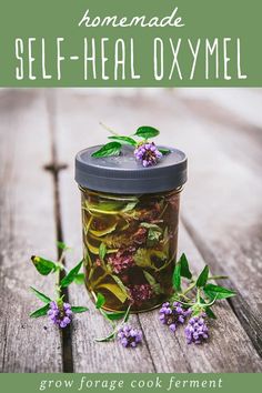 homemade self - healoxymel with flowers and herbs in a jar on a wooden table