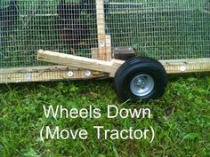 the wheels down move tractor are attached to a fenced in area with green grass