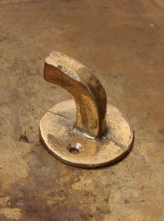 a metal object sitting on top of a dirty floor