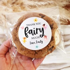 a hand holding a cookie with the words thank you fairy much love and hugs on it