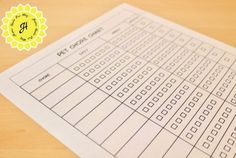 a close up of a sheet of paper on a wooden table with a yellow seal