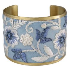 This stunning cuff bracelet boasts a light blue mesh fabric adorned with intricate floral embroidery in shades of white and blue. 
Handmade in India
Vintage embroidered fabric bracelet
Light blue and white floral cuff
Measures: 2" wide (approx.)
Materials: Gold Tone Metal, Fabric Floral Cuff, Mountain Jewelry, Fabric Bracelets, Metal Fabric, Blue And White Floral, Embroidered Fabric, Shades Of White, Floral Earrings, Gold Tone Metal