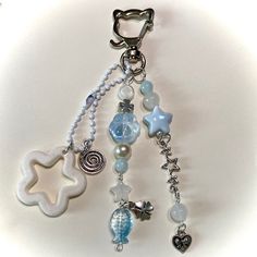 a close up of a key chain with charms on it's end and a star