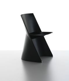 a black chair sitting on top of a white table