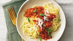 a white plate topped with spaghetti and sauce